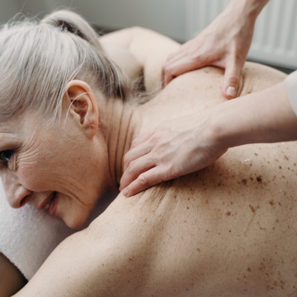 Older woman getting massage at home